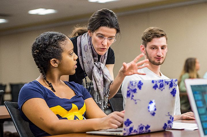 A faculty member instructs two students in class.